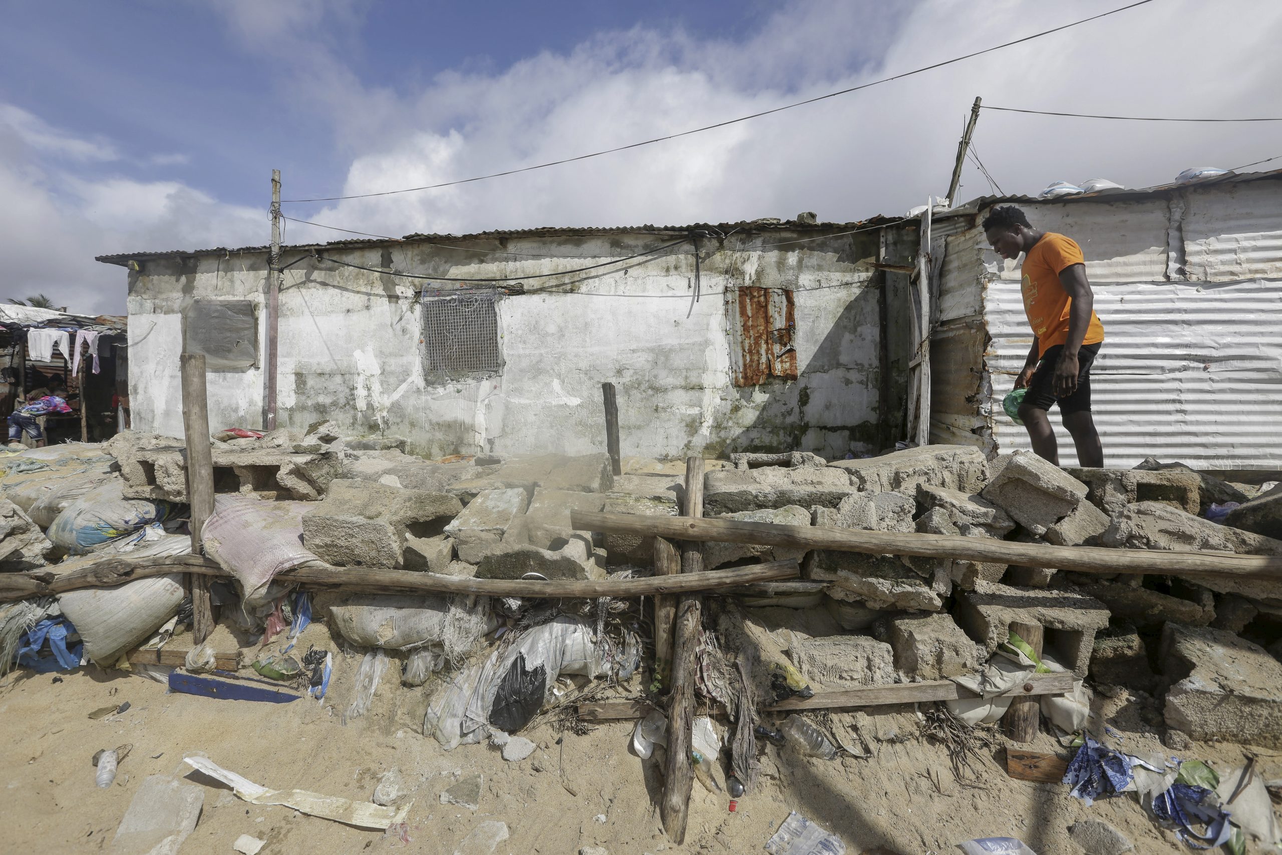 A Liberian man walks along a community built protection wall against sea erosion in West Point coastal slum community in Monrovia, Liberia October 23, 2021. EPA/AHMED JALLANZO/IPI