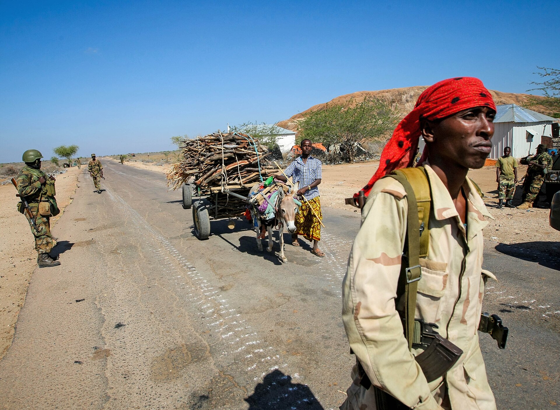 A Somali National Army soldier on the road at Burhakaba, on the Afgooye–Baidoa corridor, on 27 February 2013, the day the army and AMISOM took the town from Al-Shabaab. File photo. Stuart Price/AU-UN IST, via AMISOM Public Information, CC0, Wikimedia Commons.