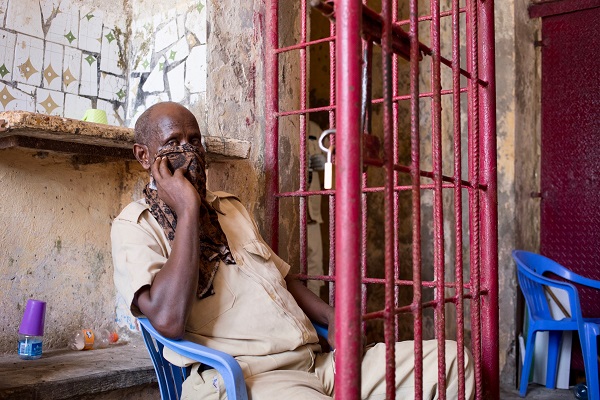 A guard at Mogadishu central prison covers his face with a piece of cloth.